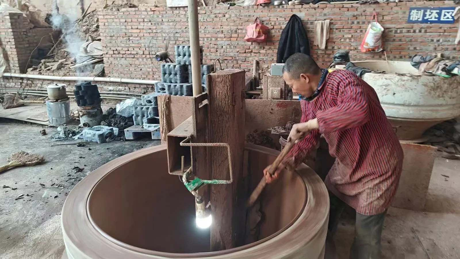 Artisan finishing ceramic wine amphora with detailed surface craftsmanship